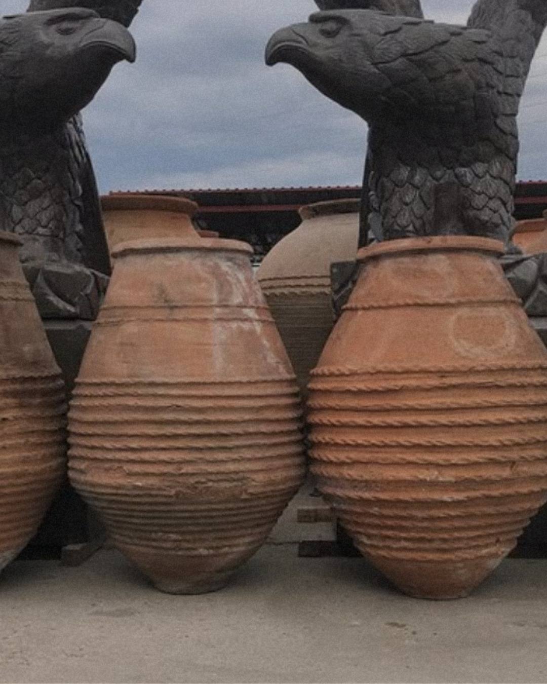 Pair of monumental belted terracotta jars for a hotel entrance