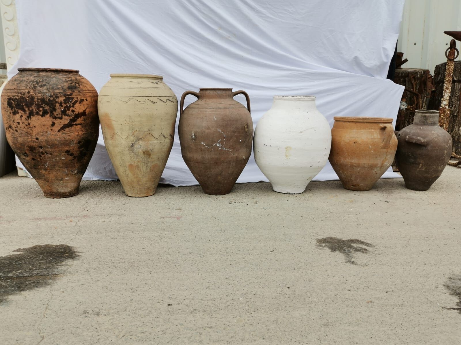 Mid-Size Anatolian Pot — row of mid-size Anatolian pots in terracotta, cream and brown
