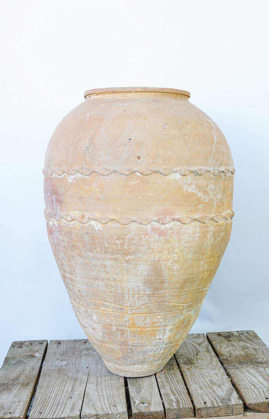 Belted Amphora — tall cream belted amphora on a wooden pallet
