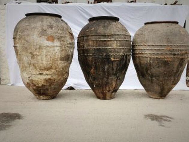 Double-Belted Amphora — three tall weathered amphorae with rope-like raised bands