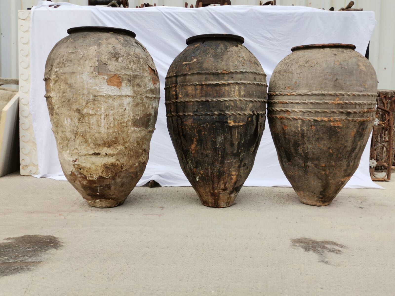 Double-Belted Amphora — three tall belted amphorae in weathered brown and grey