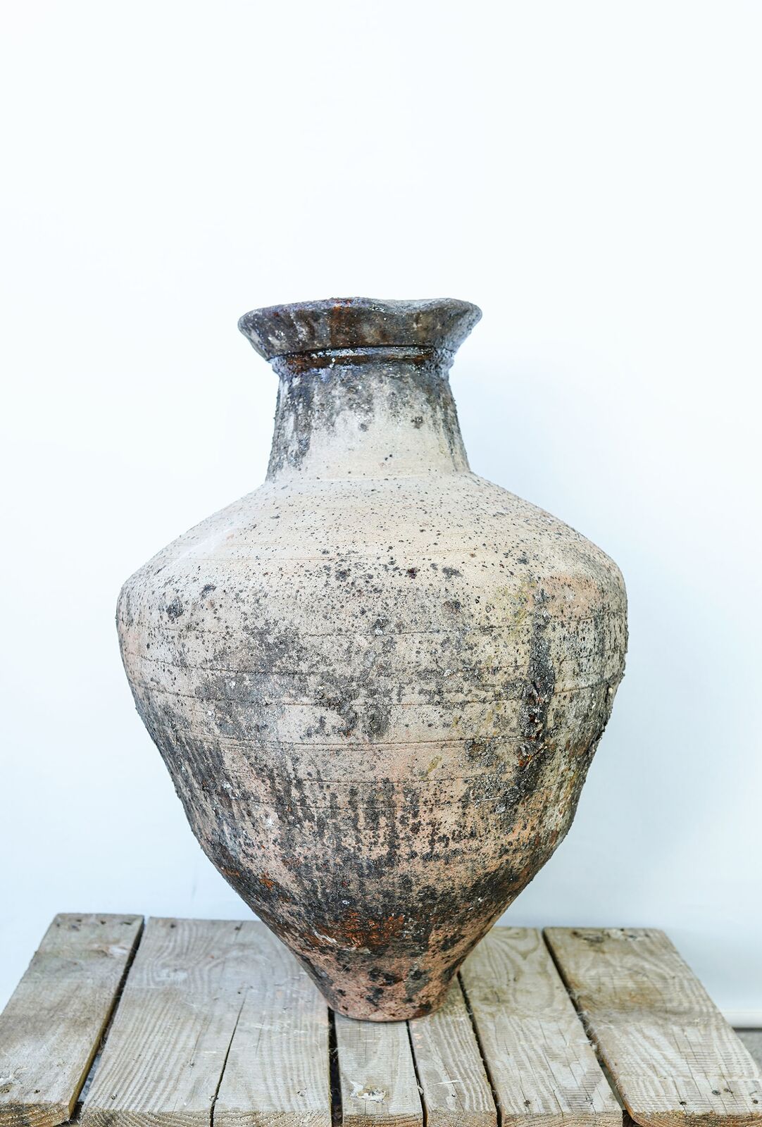 Enez Jar, Large — tall grey weathered jar with a flared neck on a wooden pallet