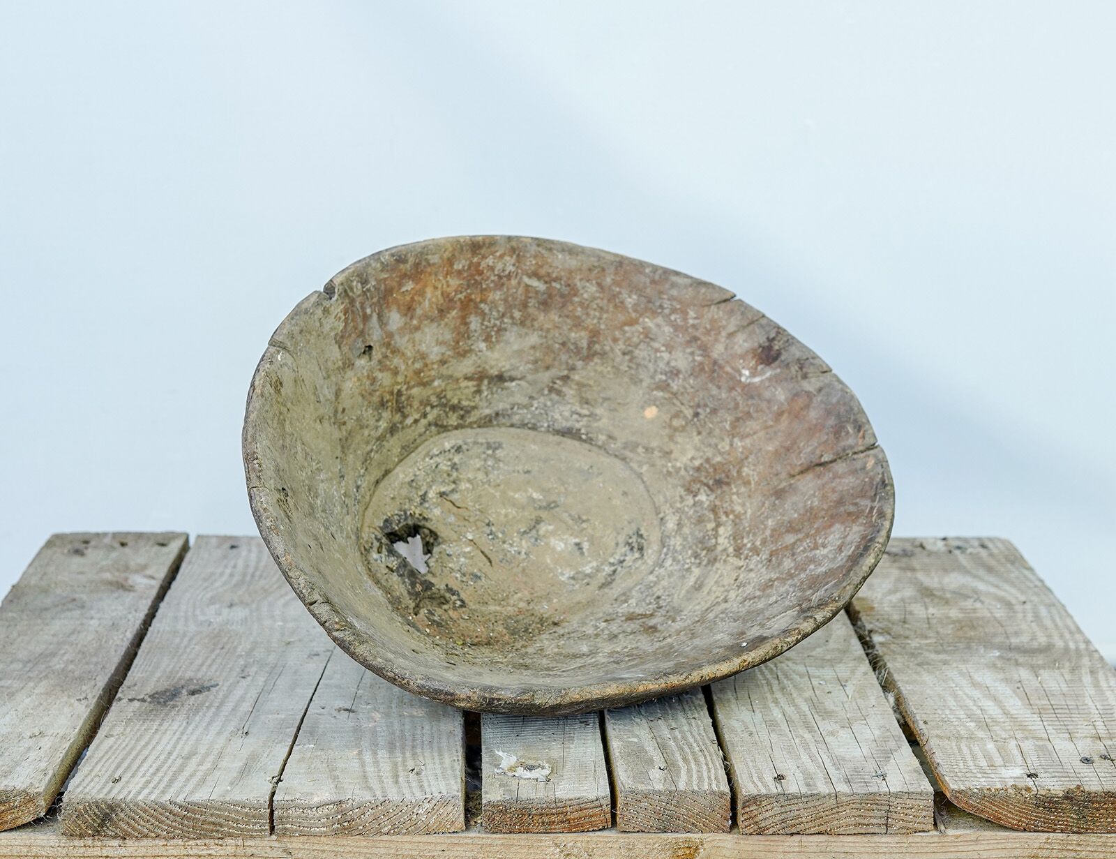 Wooden Trough, Round — large oval wooden trough with a weathered surface on a pallet