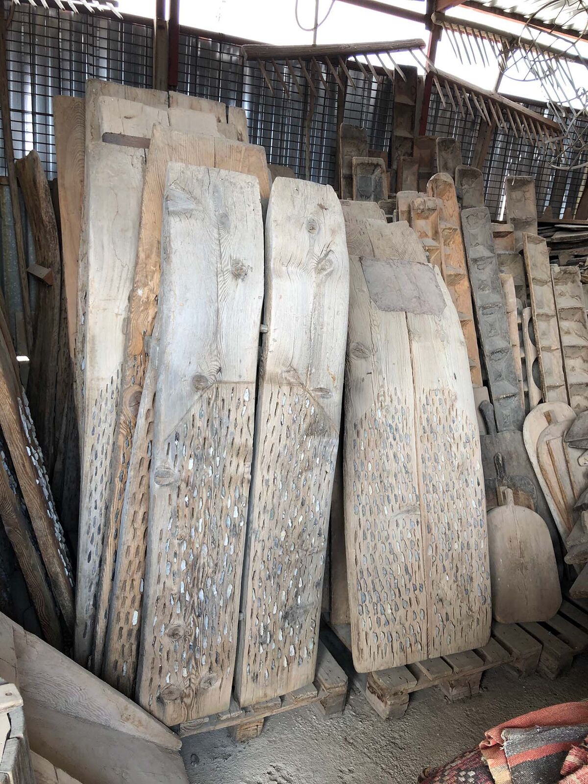 Düven Threshing Board — stack of old threshing boards in a yard