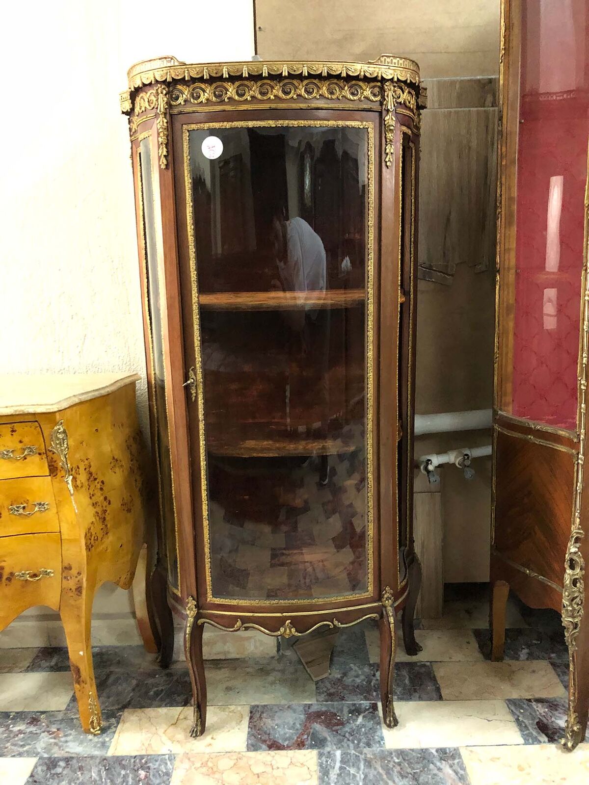 Carved Wooden Cabinets and Vitrines — bow-fronted glass vitrine with gilt mounts