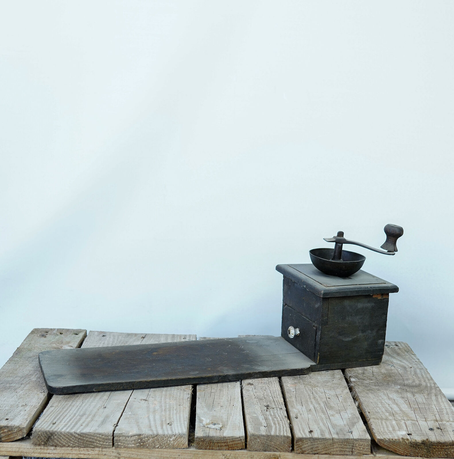 Wooden Coffee Grinder — dark wooden box coffee grinder with an iron crank handle