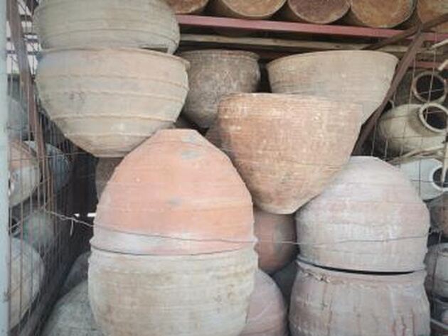 Dağar Storage Jar — stacked buff and terracotta storage jars and bowls on shelving