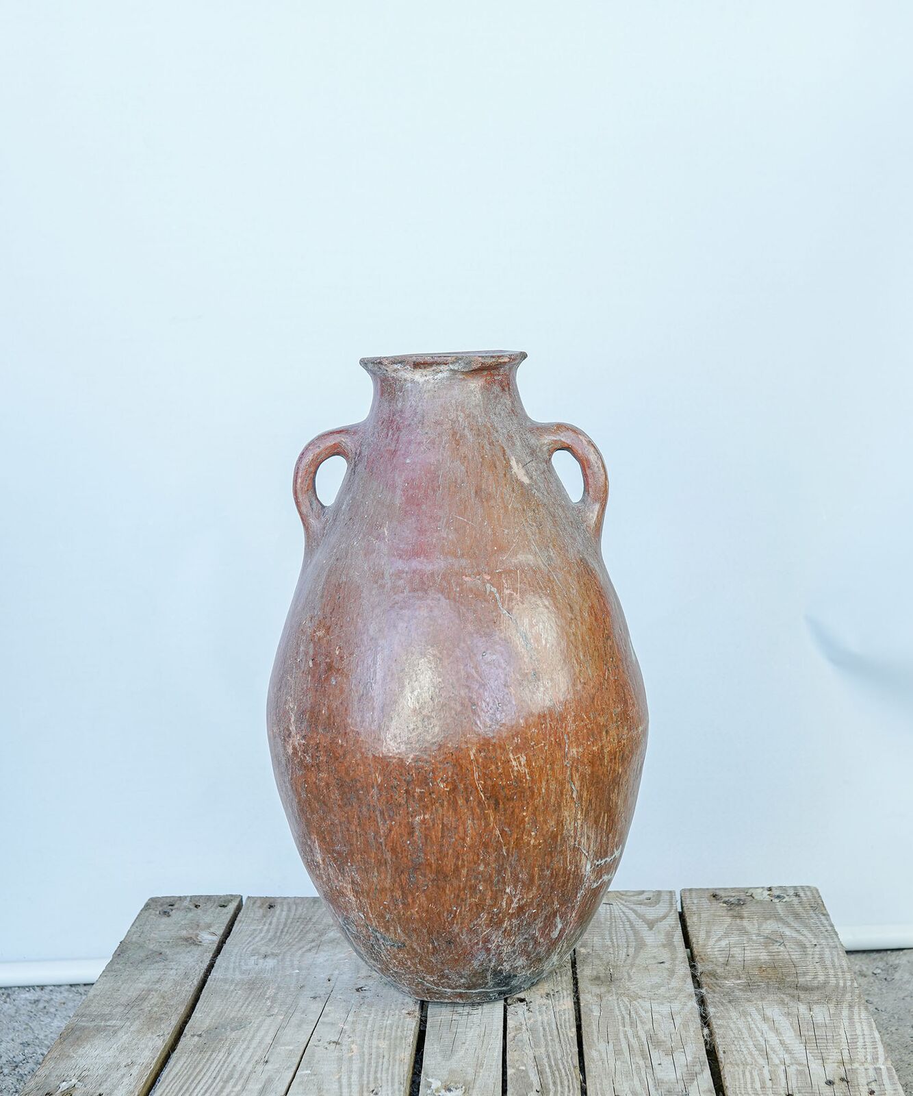 Erzurum Jar, Large — tall orange-glazed two-handled jar on a wooden pallet
