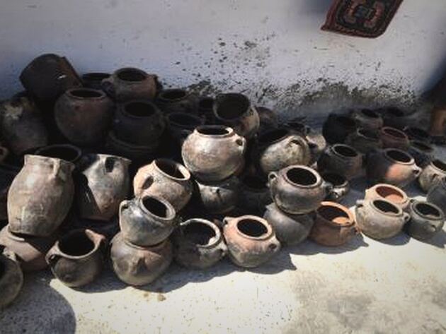 Erzurum Food Jar — small dark and terracotta handled pots piled on a white floor