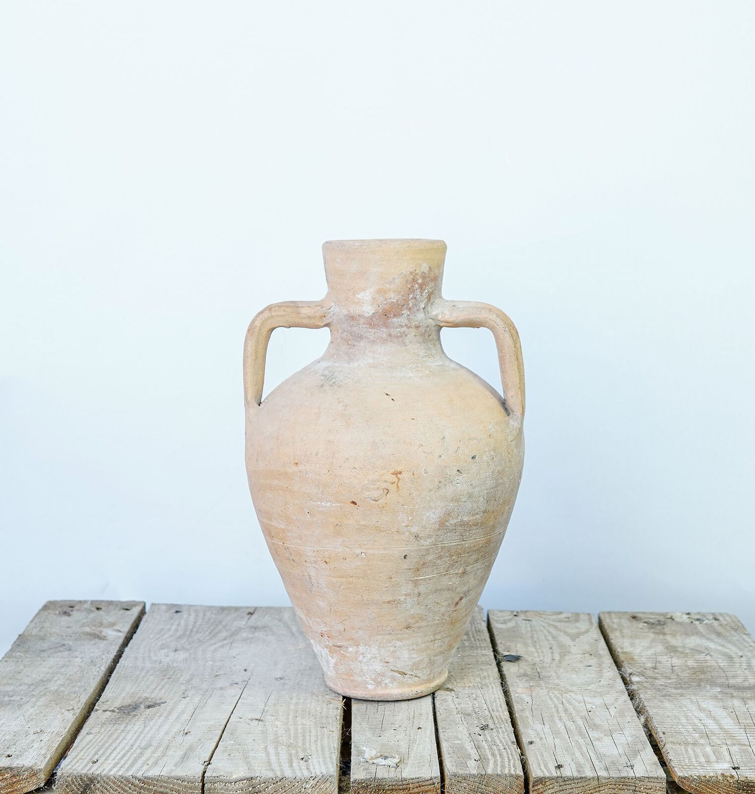 Hatay Two-Handled Jar, Small — small pale terracotta jar with two handles on a wooden pallet