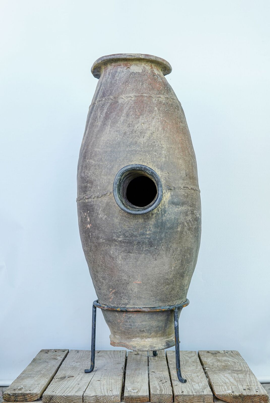 Muş Churn Jar — tall narrow clay churn with a side opening on an iron stand