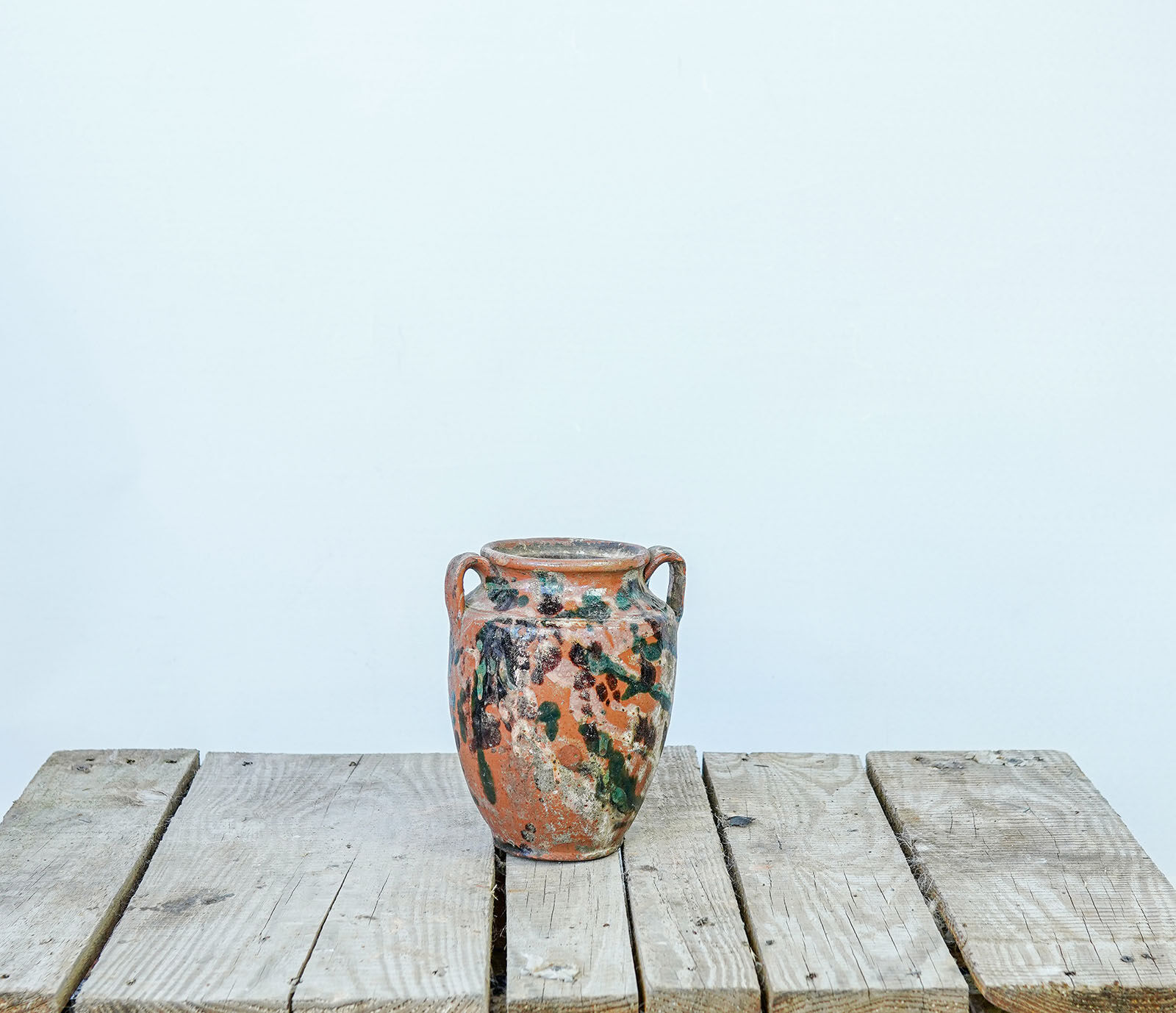 Kınık Splash-Glazed Jar — small two-handled clay jar with orange and green splash glaze