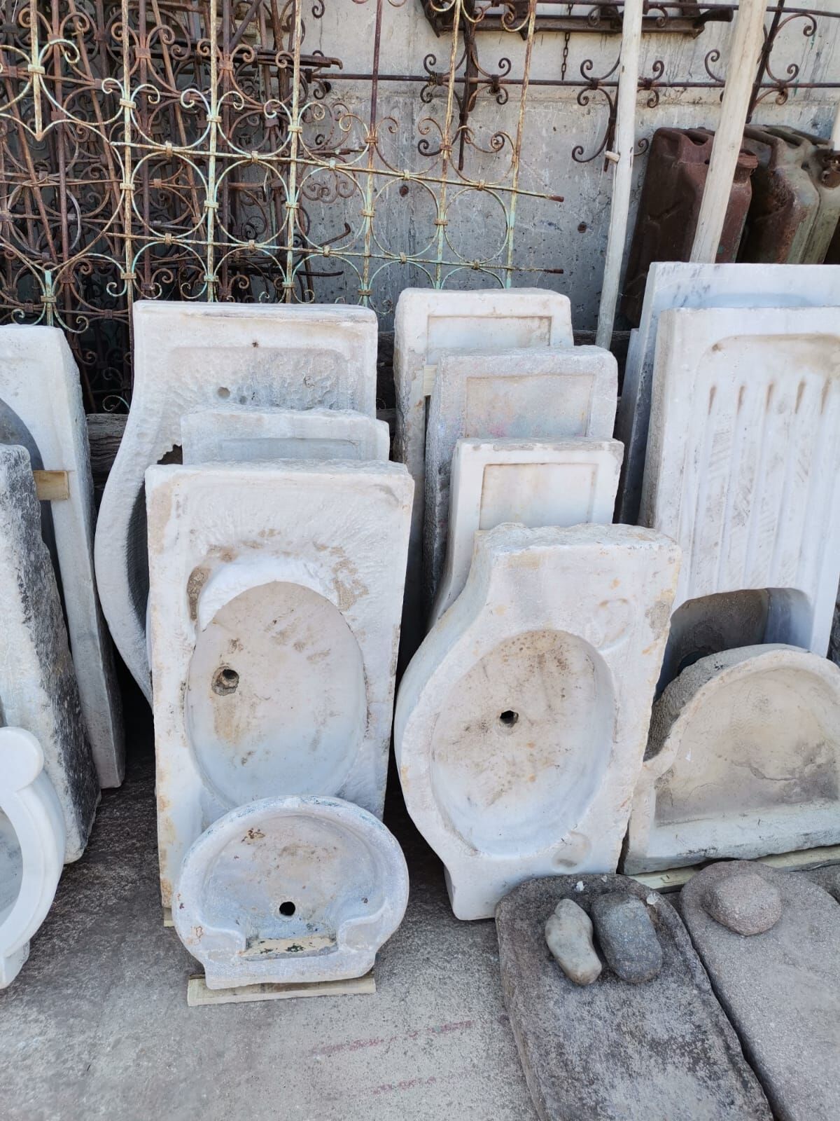 Marble Sink Basin — marble sinks standing upright in a yard