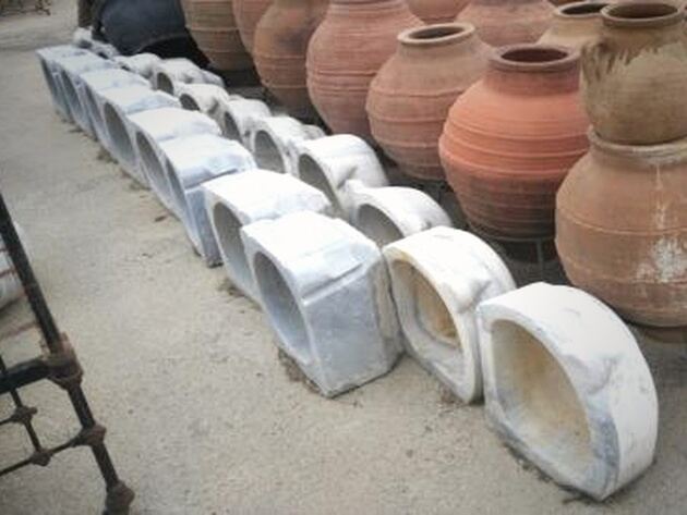 Marble Wash Basin — row of white marble basins in front of terracotta jars