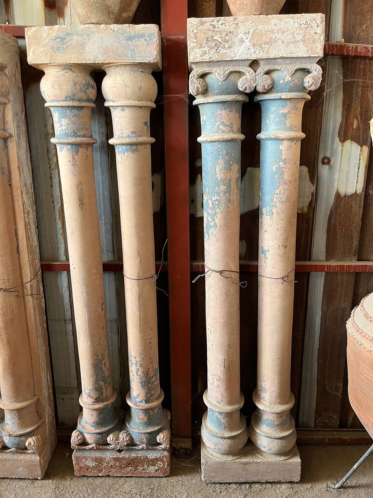 Pair of Columns — two pairs of slender columns with capitals and bases, traces of blue and cream paint