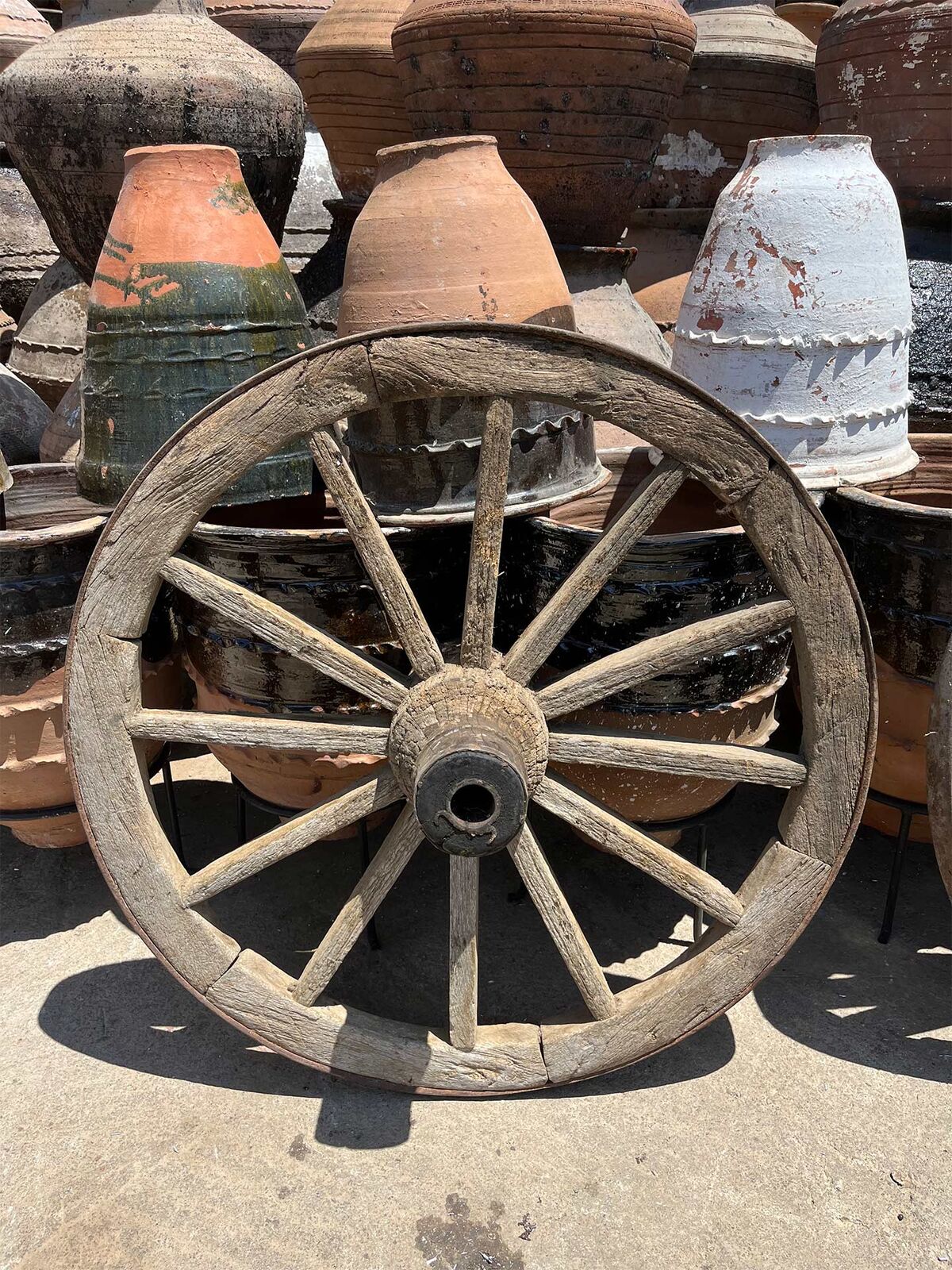 Antique Cart Wheel — spoked wooden cart wheel with weathered grey timber