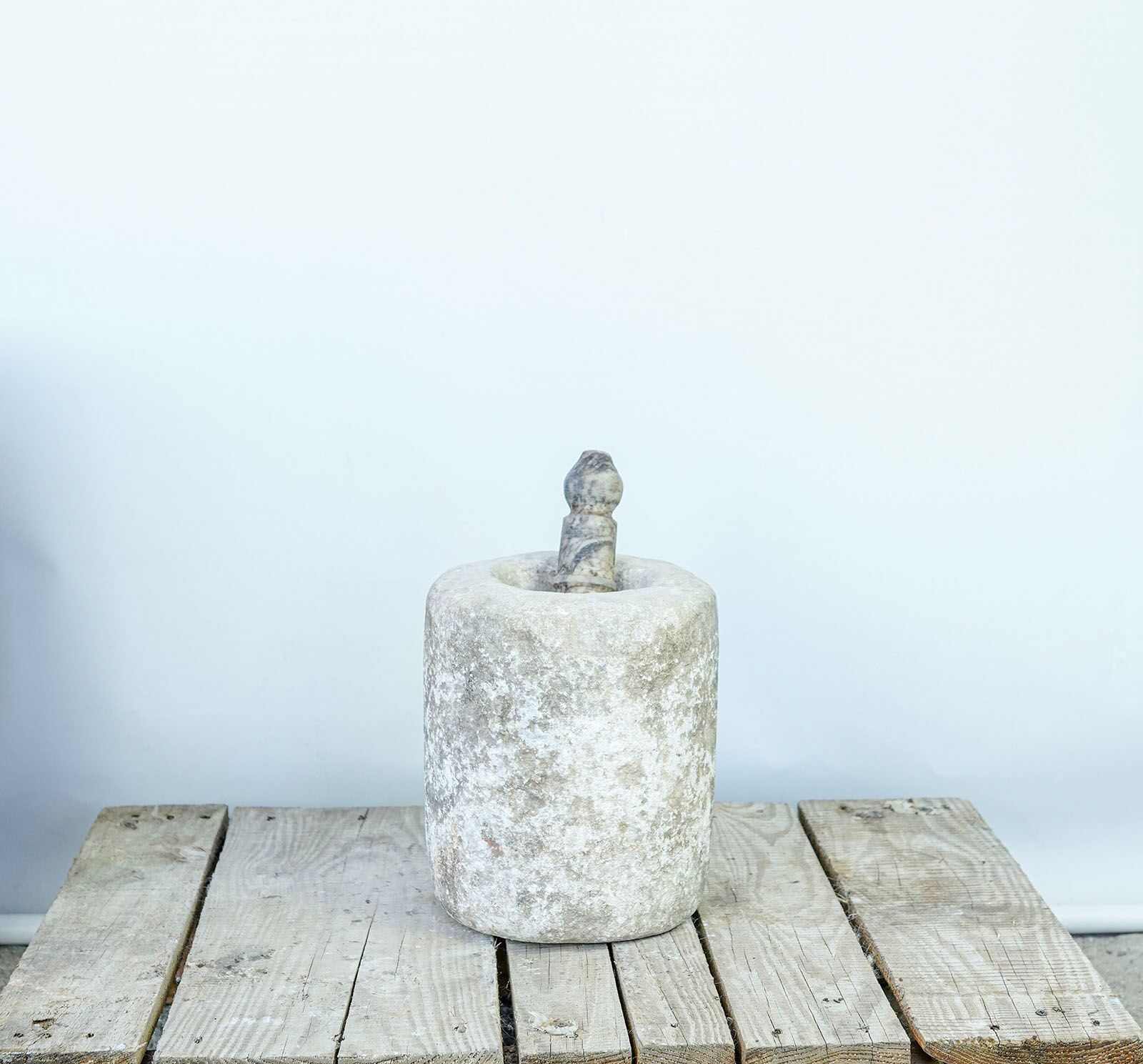 Stone Mortar — small stone mortar with a pestle on a pallet