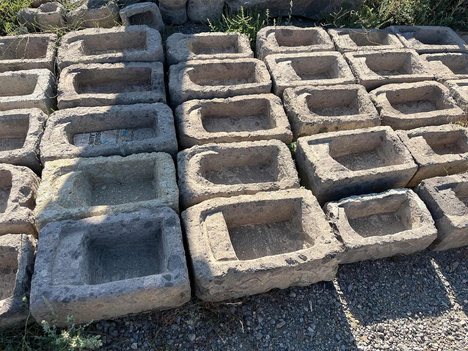 Stone Dibek Mortar — rows of rectangular stone mortars on the ground
