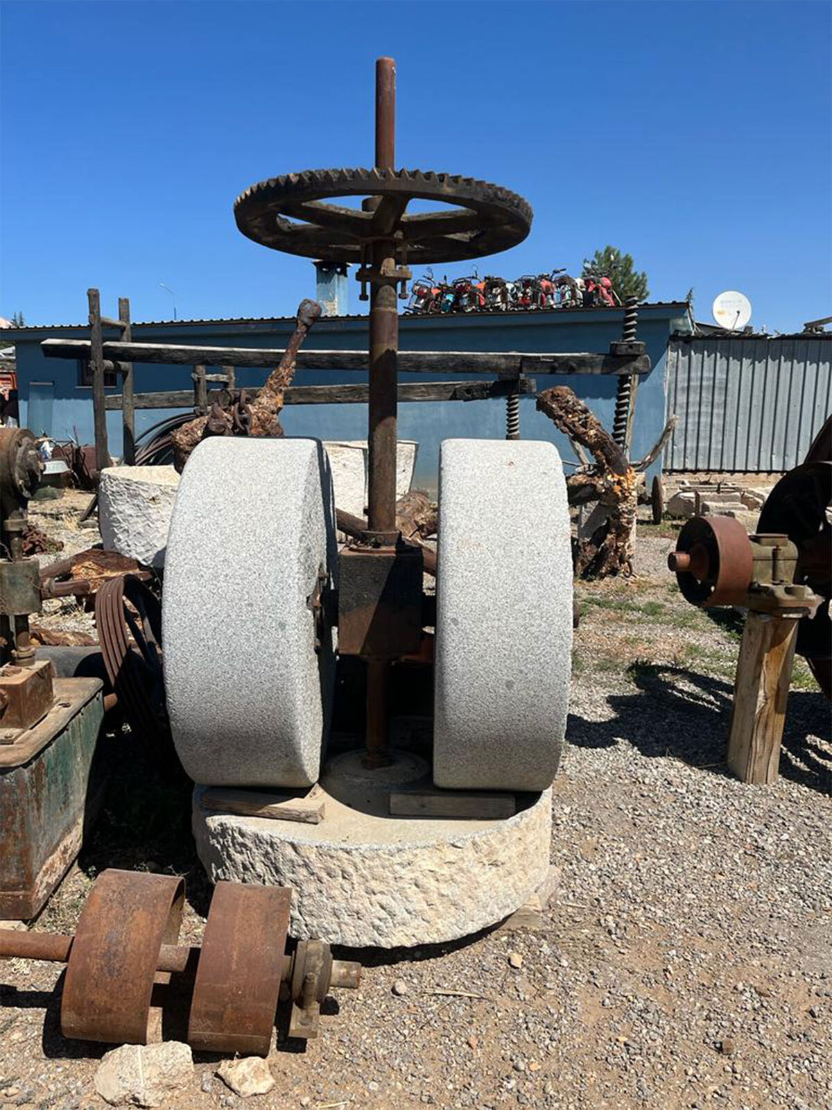 Stone Mill Set — two upright millstones on an iron gear frame