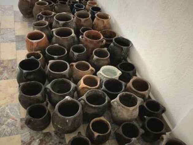 Bayburt-Erzurum Pot, Set I — grid of small black and terracotta handled pots on a marble floor