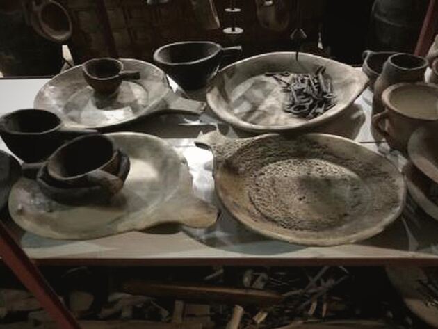 Marble Serving Plate — grey stone serving plates and dark bowls displayed on a shelf