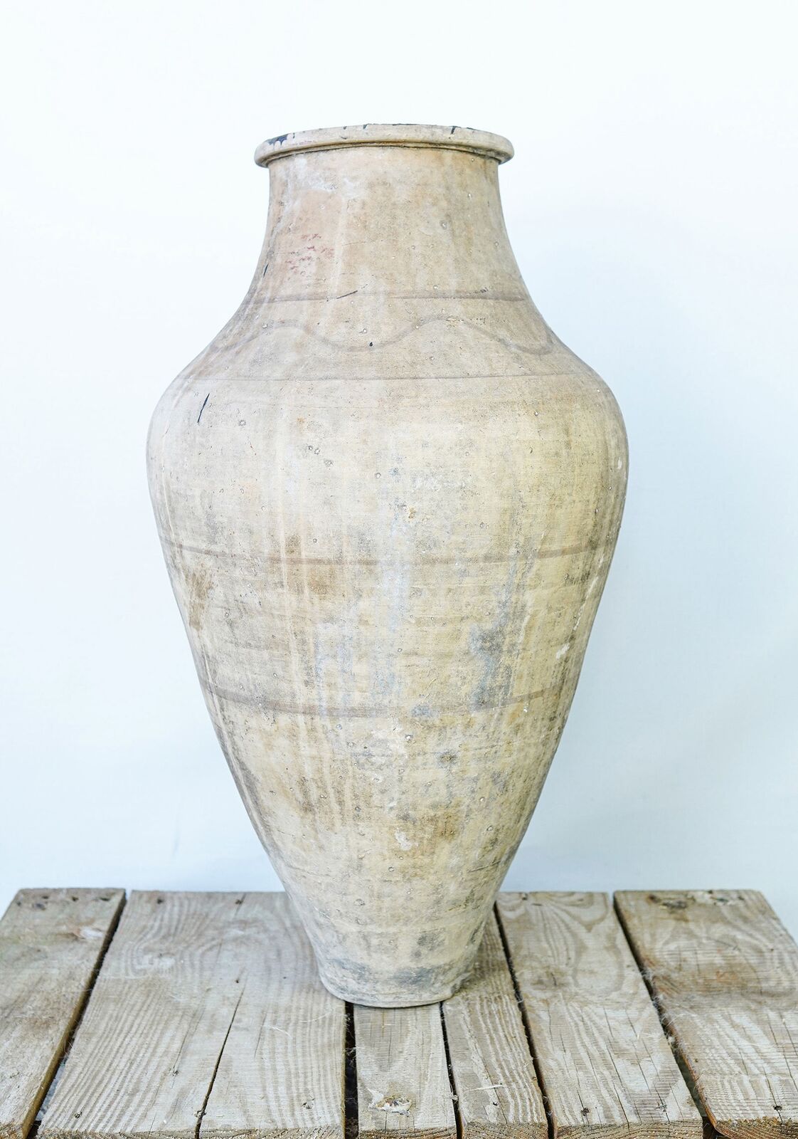 Avanos Pottery Jar — tall pale amphora with a banded body on a wooden pallet