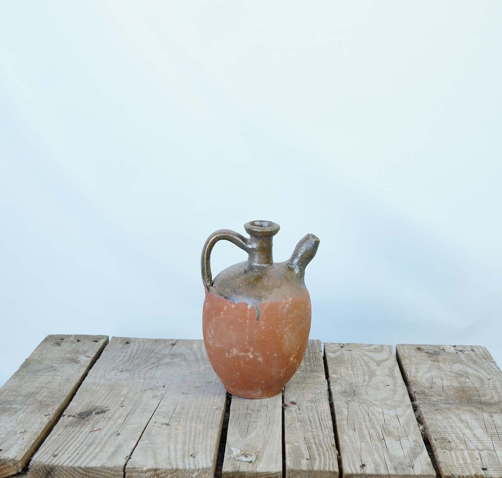 Konya Glazed Bottle Jug — small amber glazed jug with a narrow neck on a wooden pallet