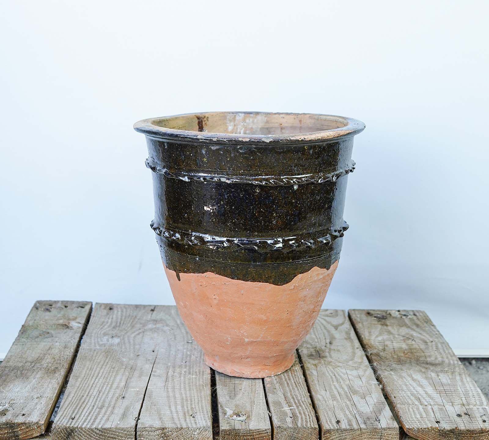 Glazed Dağar Bowl, Small — stack of dark glazed bowls with terracotta bases on a pallet