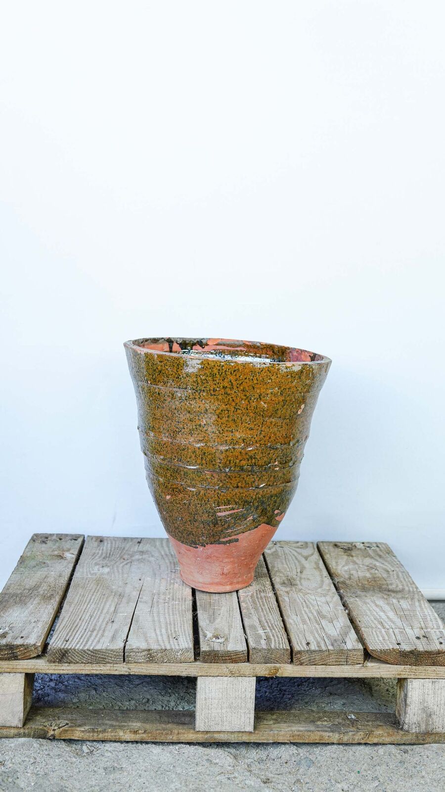 Glazed Dağar Bowl, Small — small olive-glazed pot on a wooden pallet