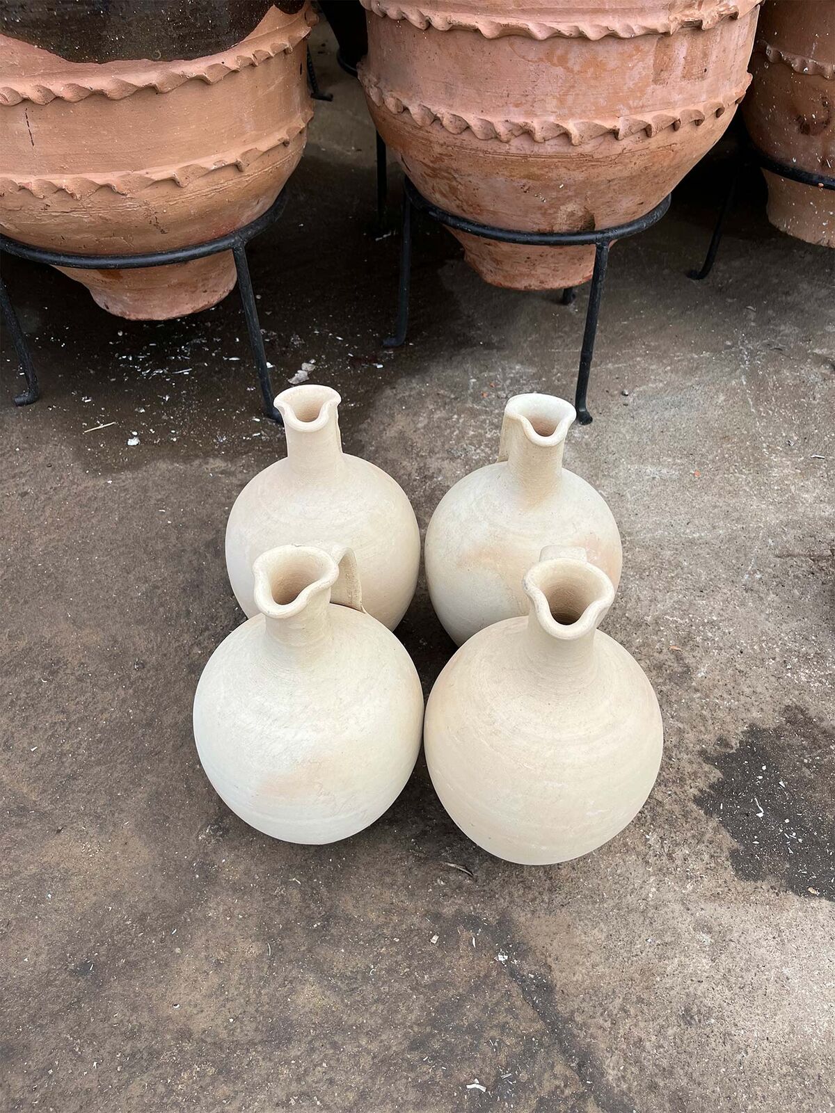 Avanos Water Jug — four white jugs with narrow necks on a concrete yard