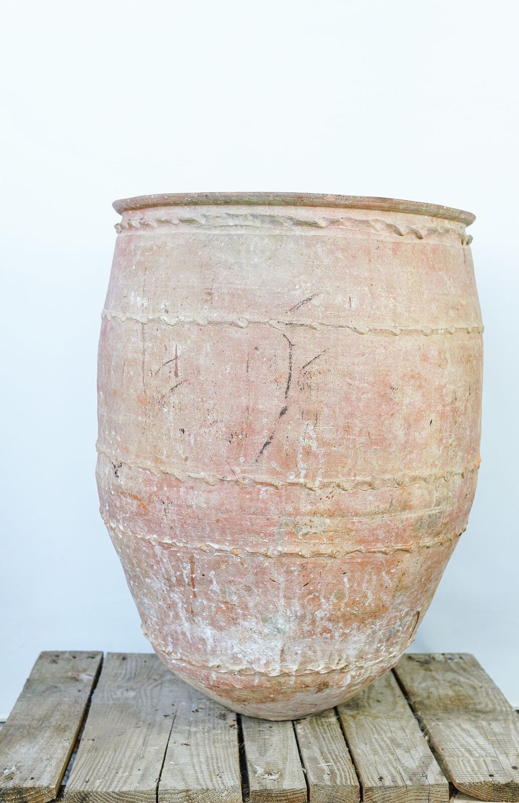 Dağar Pottery, Medium — large pale terracotta belted jar on a wooden pallet