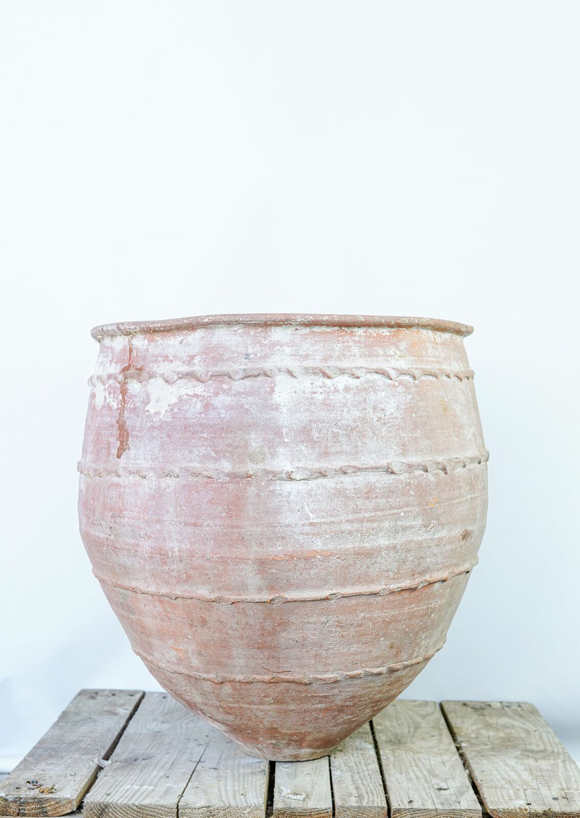 Dağar Pottery, Large — large pink-white belted jar with a wide mouth on a wooden pallet