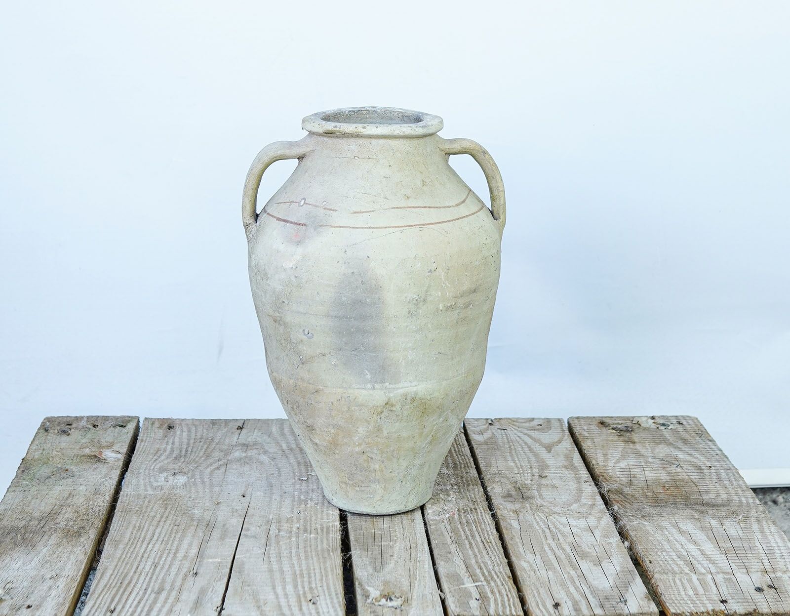 Avanos Two-Handled Amphora — cream clay amphora with a rounded body on a wooden pallet