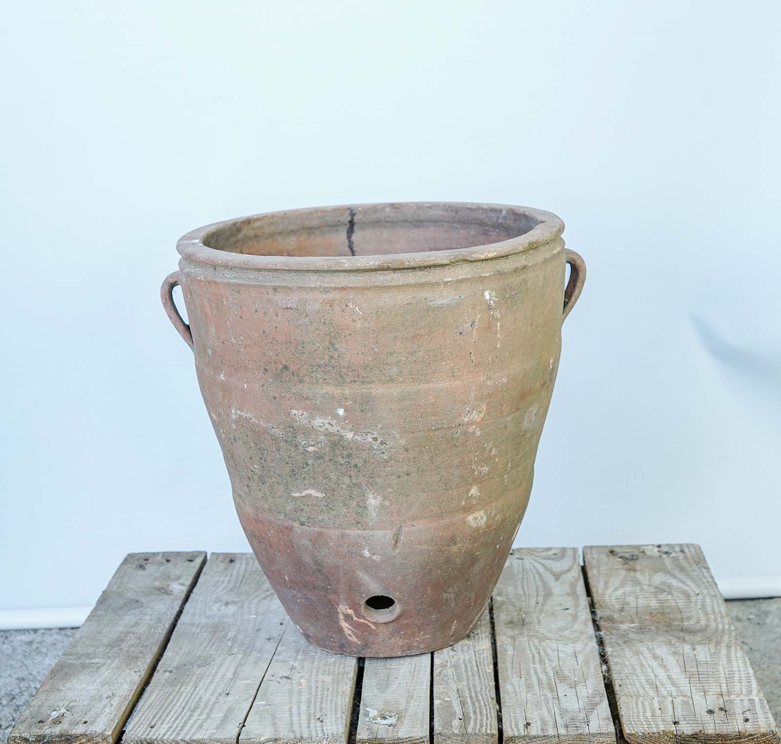 Ribbed Dağar Jar with Spout Hole — wide ribbed terracotta jar with two handles and a spout hole on a pallet