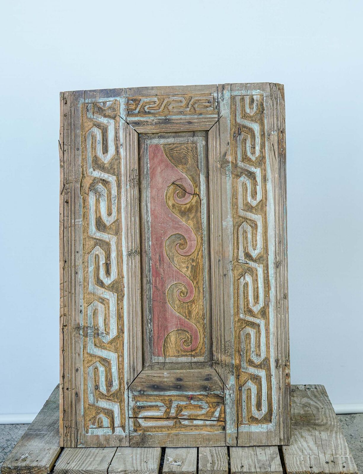 Carved Door, Key Border — pale wooden door panel carved with a key-pattern border on a pallet