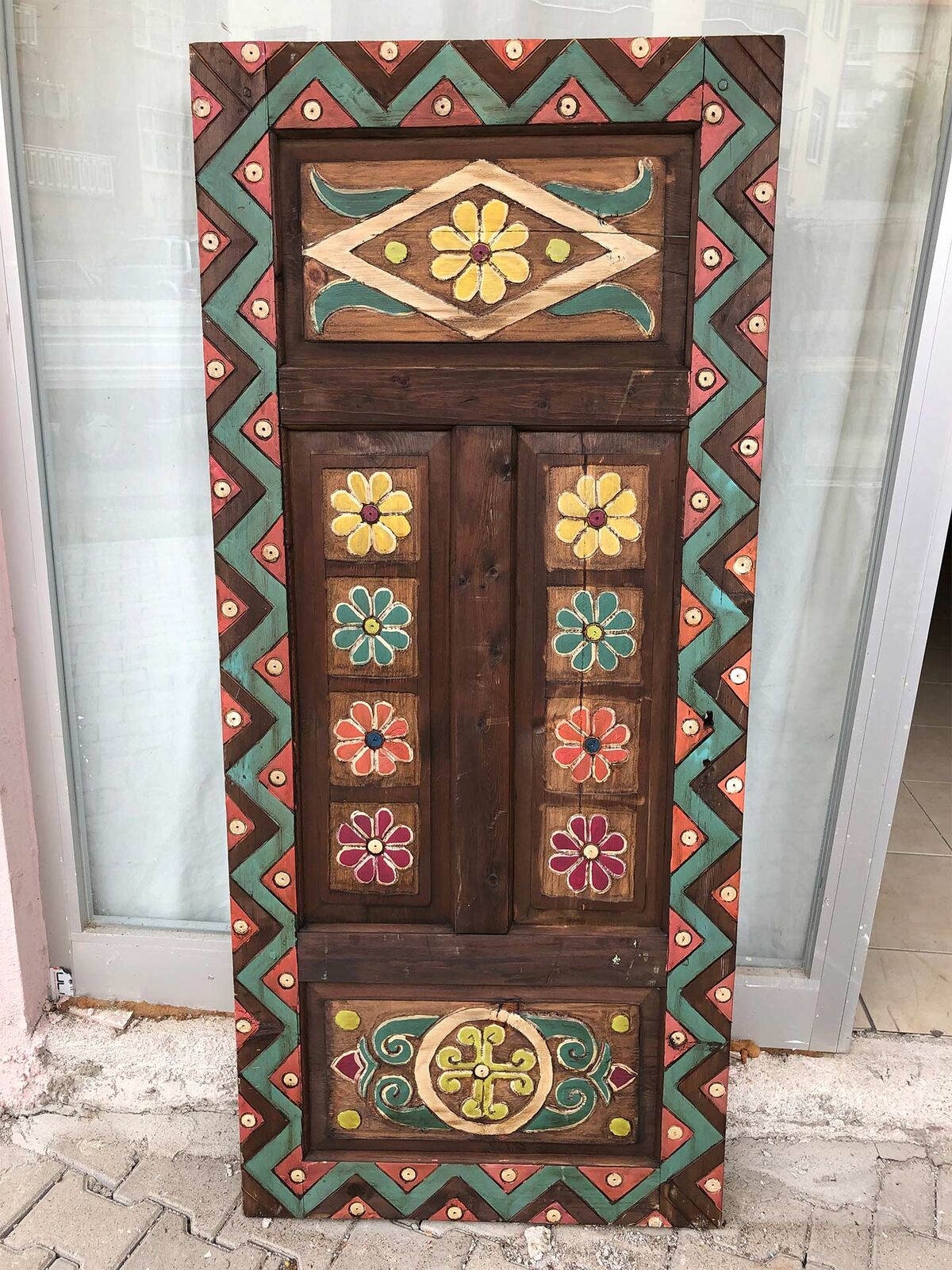 Painted Door, Geometric Border — painted wooden door with flower panels and a green zigzag border