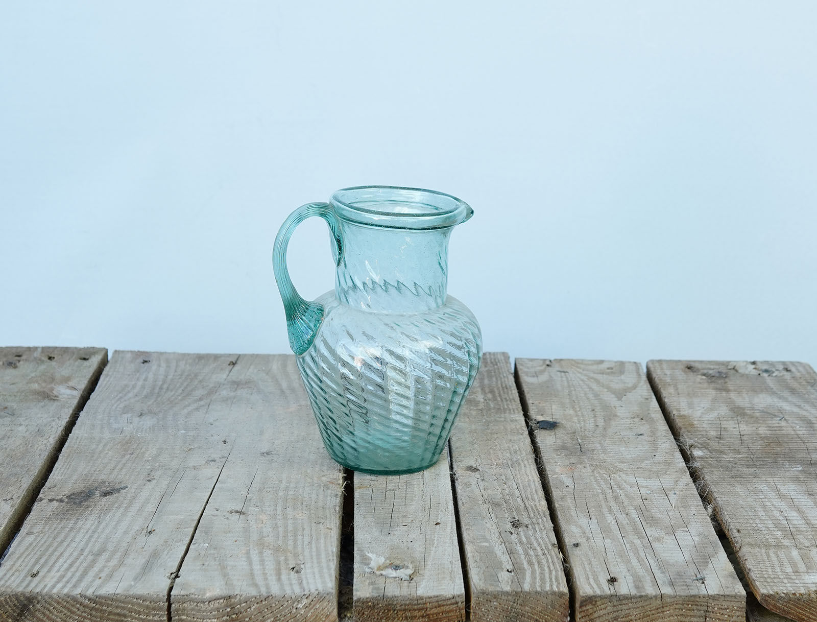 Glass Carafe — pale aqua glass carafe with a swirled ribbed body and handle