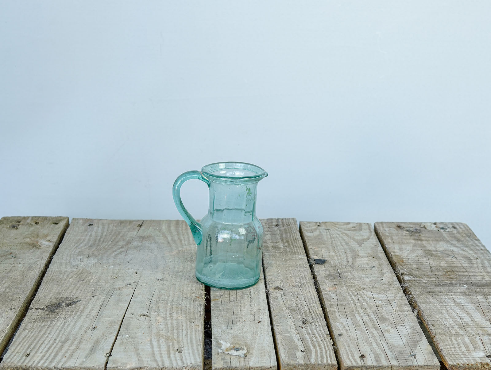 Glass Carafe — small pale aqua glass jug with a handle
