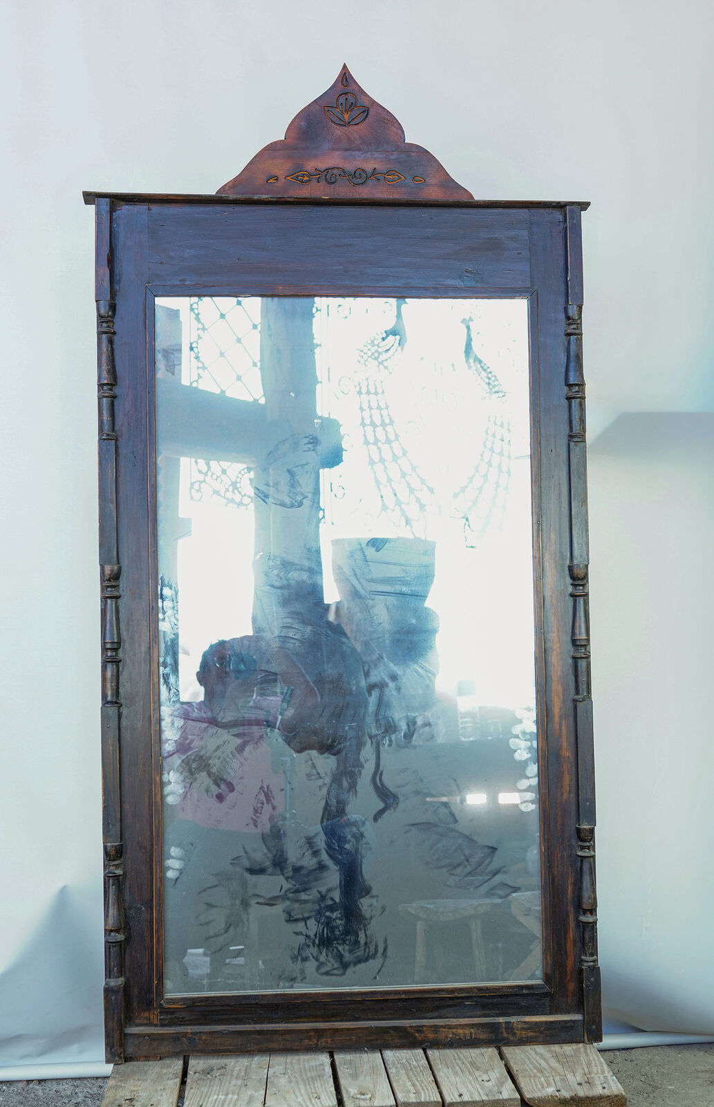 Wooden Framed Mirror with Crest — tall mirror in a dark wooden frame with turned side columns and a pointed carved crest